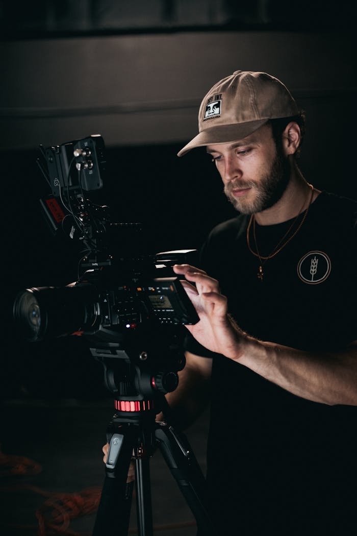 A cinematographer sets up a camera on a film set, focusing on preparation for shooting.